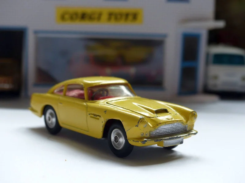 N - Scale Model Train Layout with a City - Themed Background and Animated Figures218 Aston Martin in yellow with fixed wheels and open vent N - Scale Model Train Layout with a City - Themed Background and Animated Figures218 Aston Martin in yellow with fixed wheels and open vent