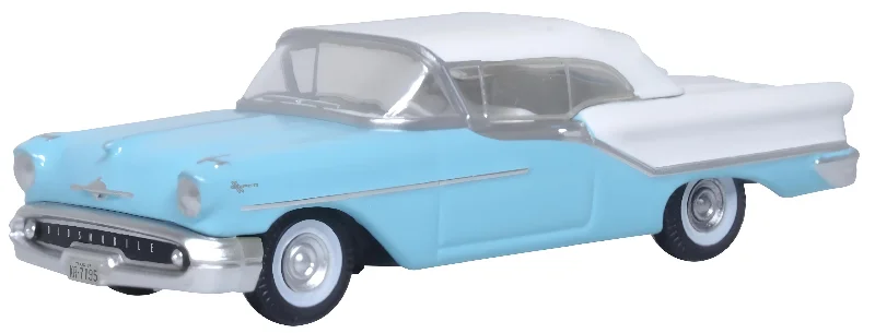 N - Scale Model Train Layout with a City - Themed Background and Animated FiguresModel of the Banff Blue/Alcan White Oldsmobile 88 Convertible 1957 (Roof Up) by Oxford at 1:87 scale.